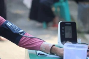 A person’s arm with a blood pressure cuff indicating hypertension as one of many clonidine withdrawal symptoms.