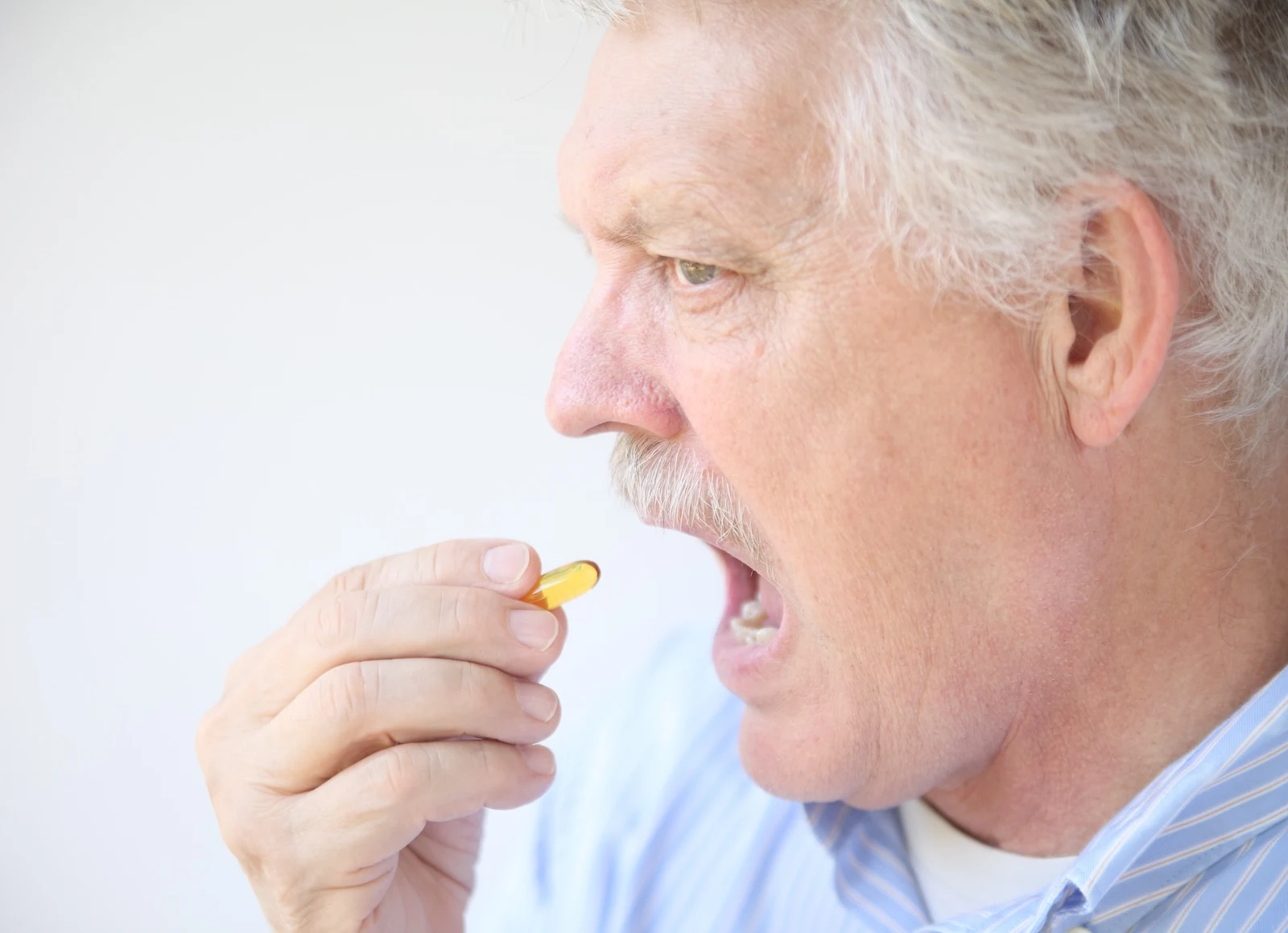 man taking a cough drop