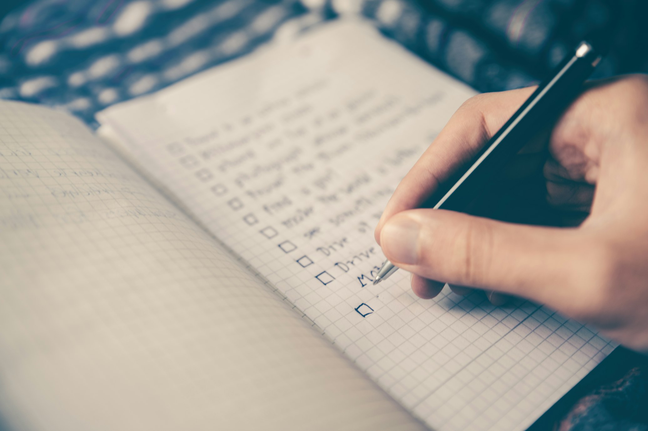 Person writing by hand in a journal, representing the personal reflection involved in building a relapse prevention plan